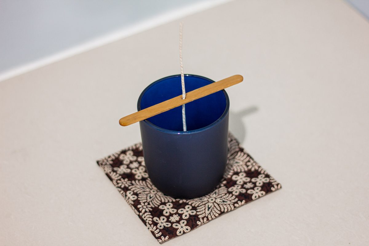 A cotton wick, centered in each glass