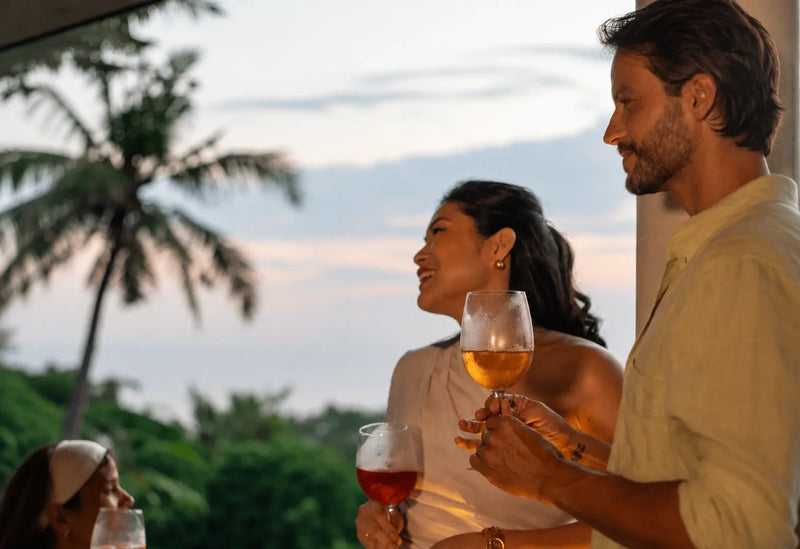 Melati Drinks gathering at sunset with friends enjoying botanical drinks outdoors.